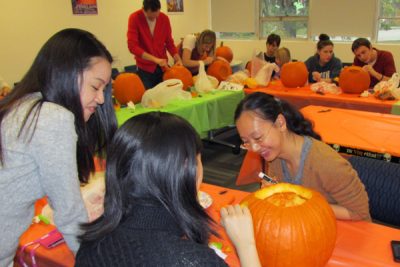 photo of COMM grad students carving pumpkins